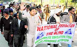 Visually impaired from Punjab take out a protest rally in support of their demands in Sector 34, Chandigarh, on Tuesday