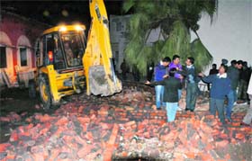 Illegal chambers of lawyers being demolished at the courts complex in Amritsar on Tuesday