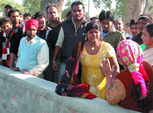 A woman consoles the victims mother (in yellow suit) at the spot of accident, in Bathinda on Wednesday.