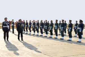 Air Marshal Arup Raha, AVSM, VM , AOC-in-C of Western Air Command, IAF, inspects the guard of honour at the Air Force Station in Bhisiana on Tuesday; his wife Lily Raha (below) meets children at a welfare institution .