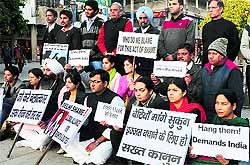 Members of an NGO hold a protest at Plaza, Sector 17, in Chandigarh on Wednesday