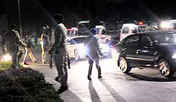 Police vehicles zoom past each other after the UT SSP directed policemen to man city roads and ensure the safety of women; and (below) policemen disperse after the meeting