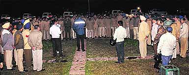 UT SSP Naunihal Singh (with his back towards the camera) addresses a gathering of policemen to direct them to ensure safety of women returning home after attending ladies night out at several discotheques and bars in Chandigarh on Wednesday night