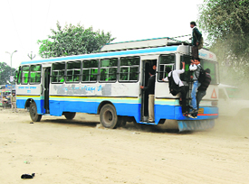 A bus plies on a kutcha road in Jind on Wednesday.