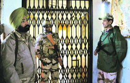 Paramilitary personnel keep watch outside a strongroom where voting equipment is kept, in Shimla on Wednesday.