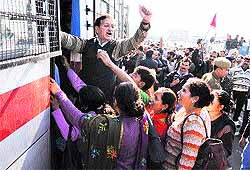 Members of Centre of Indian Trade Union (CITU) court arrest while protesting at Indira Chowk in Jammu on Wednesday