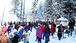 Tourists wait for their turn to board a gondola at the World Ski Resort in Gulmarg
