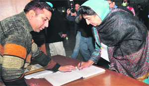 Congress MLA Rajinder Kaur Bhattal signs the attendance register at the Punjab Vidhan Sabha in Chandigarh on Wednesday.