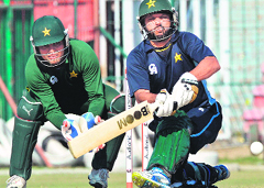 Shahid Afridi sweeps during a training camp in Lahore on Wednesday.  AFP