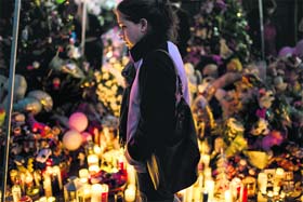 A woman visits a makeshift memorial in Newtown