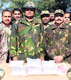 BSF jawans with seized heroin at border post of Chanamulla near Amritsar on Thursday.