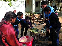 Students of a government primary school wash untensils after having their mid-day meal in Muktsar