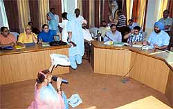 A female municipal councillor squats on the floor to put her point across during a general house meeting of the Municipal Corporation Bathinda held in July