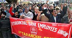 Bank employees hold a protest march in Dehradun on Thursday