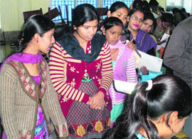 College students line up for preparation of their Aadhar cards at Geeta Vidya Mandir Girls College, Sonepat, on Thursday. 
