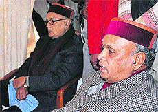 Outgoing Chief Minister PK Dhumal watches election results on television at the Circuit House in Hamirpur on Thursday.