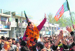 State BJP president Satpal Singh Satti with supporters after victory in Una on Thursday.