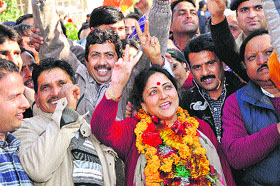 Sarveen Chaudhary of the BJP celebrates her victory from Shahpur with supporters on Thursday.