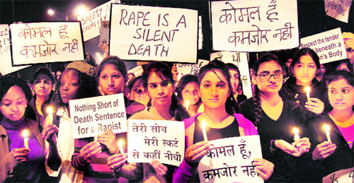 Young girls hold a candlelight march demanding death sentence for the accused in the Delhi gang-rape case in Jalandhar on Thursday.
