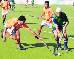 A match in progress between BRC, Danapur, and Government School, Jharkar, during the All-India Balwant Singh Kapur Hockey Tournament in Jalandhar on Thursday.