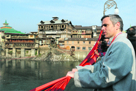 Chief Minister Omar Abdullah looks at heritage buildings on the banks of the Jhelum after inaugurating a bridge over the river in Srinagar.