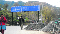 Building material dumped on Poonch-Jammu highway. A Tribune photograph