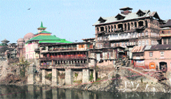 A view of the old heritage buildings at Zaina Kadal on the banks of the Jhelum. Tribune photo: amin war