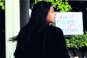 A student of the INIFD, Ludhiana, looks at a poster seeking action against the accused in the Delhi gang rape case.
