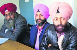 Members of the Guru Nanak Dev University Teachers Association address the media in Amritsar on Friday.