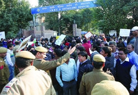 Police personnel remove the activists from the road near Safdarjung Hospital during a demonstration to protest against the recent Vasant VIhar gangrape in New Delhi on Friday.