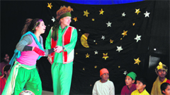 Foreign volunteers and children of Nanhi Duniya enact a play during Christmas celebrations in Dehradun on Friday. 