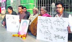 Family members of Anshu Nautiyal, who was raped and murdered two years ago, sit on a dharna in support of their demand for justice at Gandhi Park in Dehradun on Friday. Tribune photo: Vinod Pundir 