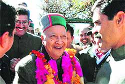 Virbhadra Singh is greeted by supporters at Holly Lodge in Shimla on Friday