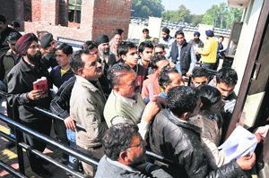 Applicants queue up outside the Regional Transport Office in Jammu.