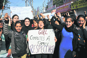College students hold a protest against Delhi gangrape case in Jammu on Friday.
