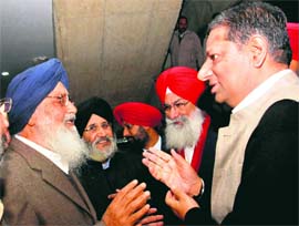 Chief Minister Parkash Singh Badal talks to Congress MLAs Ashwani Sekhri and Ajit Inder Singh Mofar at the Vidhan Sabha in Chandigarh on Friday.