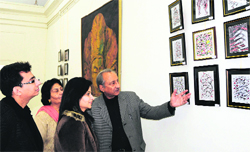 Visitors take a look at paintings at the art gallery in Amritsar on Saturday.