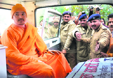 Swami Poornanand Saraswati being taken to a court at Jagjeetpur in Haridwar on Saturday. 