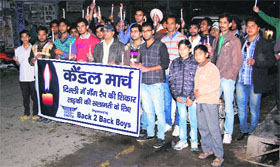 A group of boys takes out a candle march at Ellenabad in Sirsa. 
