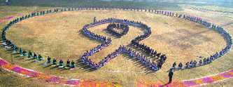School students form a red ribbon at the Guru Gobind Singh stadium in Jalandhar where an AIDS awareness rally was held on Saturday.