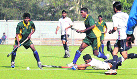 Players in action during the semifinal match of the 9th All India Balwant Singh Kapur Hockey Tournament in Jalandhar on Saturday.