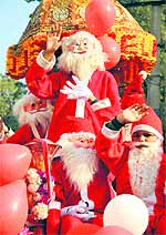 Children dressed as Santa Claus take part in a procession in Jammu on Saturday