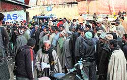 Residents await their turn for a LPG cylinder connection in Nawab Bazar, Srinagar, on Saturday