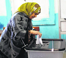 A woman casts her vote at a polling station in Giza, south of Cairo, on Saturday.