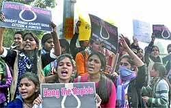 Students shout slogans during a demonstration against the Delhi gangrape in New Delhi on Sunday