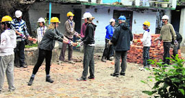 Foreign students work as labourers to build infrastructure of a school as part of the Round Square internatioanl project at Katapathar,15 km from Vikasnagar, in Dehradun.