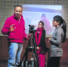 Filmmaker Daljit Ammi talks to students during the film-making workshop at Doaba College in Jalandhar on Saturday. 
