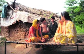 A family of refugees from West Pakistan sit outside their house at Sampur Pur Kulian village