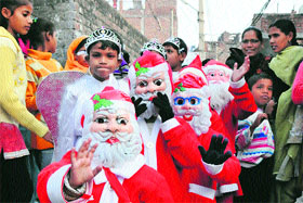 Children dressed up as Santa Claus take part in a Christmas procession in Jammu on Sunday.