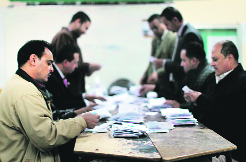 Polling station officials deposit ballots during the second round of a referendum in Giza on Saturday.